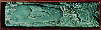 a bronze relief, showing a vish with a human face as it swims through swirling waters